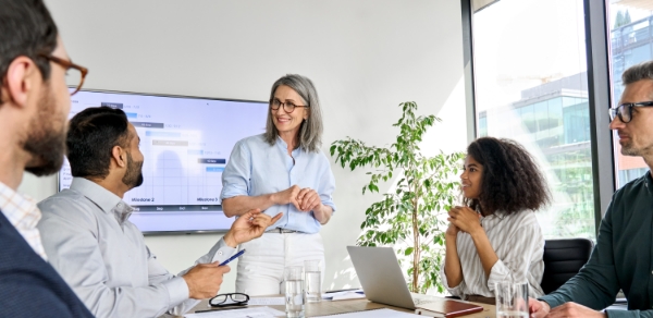 Coworkers engaging in conversation during a presentation